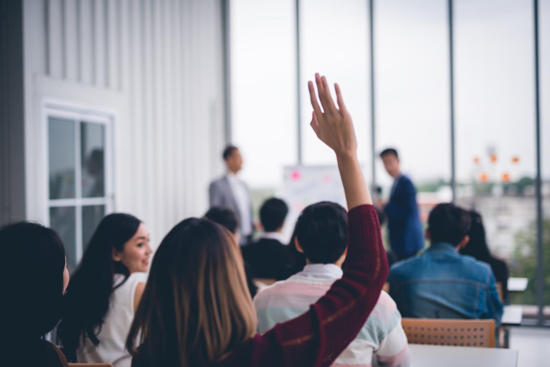 Woman asking question at meeting