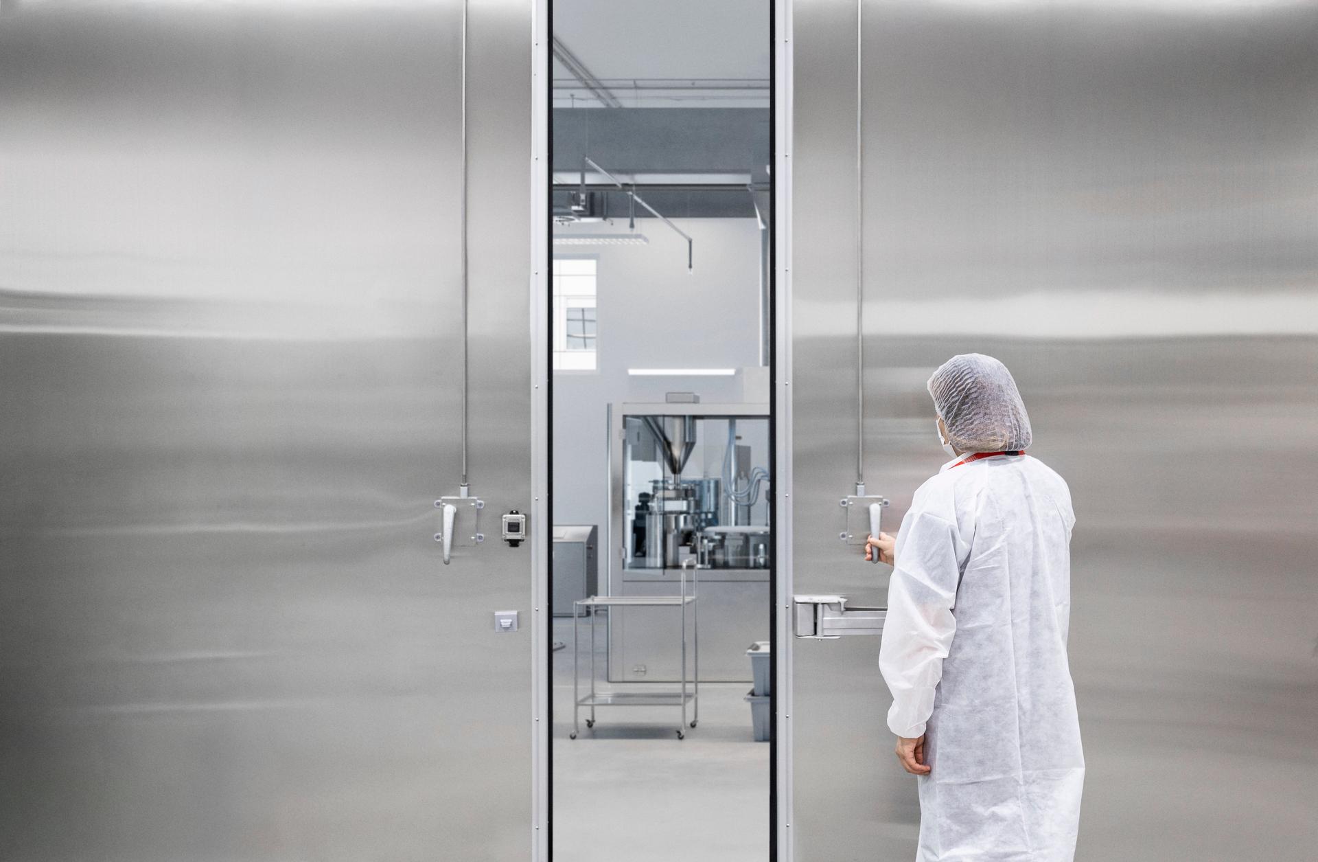 Digitally generated image of inspection laboratory in medicine production factory. 3D render of empty laboratory with scientific monitors on desks.
